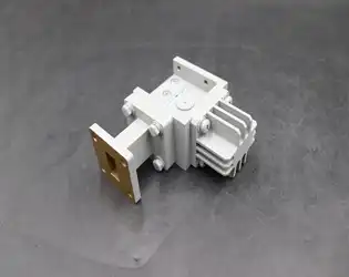 How does power handling capacity affect the design and application of waveguide isolators?